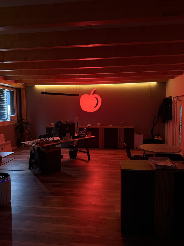 Büro von Hasan Atula e.K. in Hilden mit beleuchtetem Apfel-Logo an der Wand